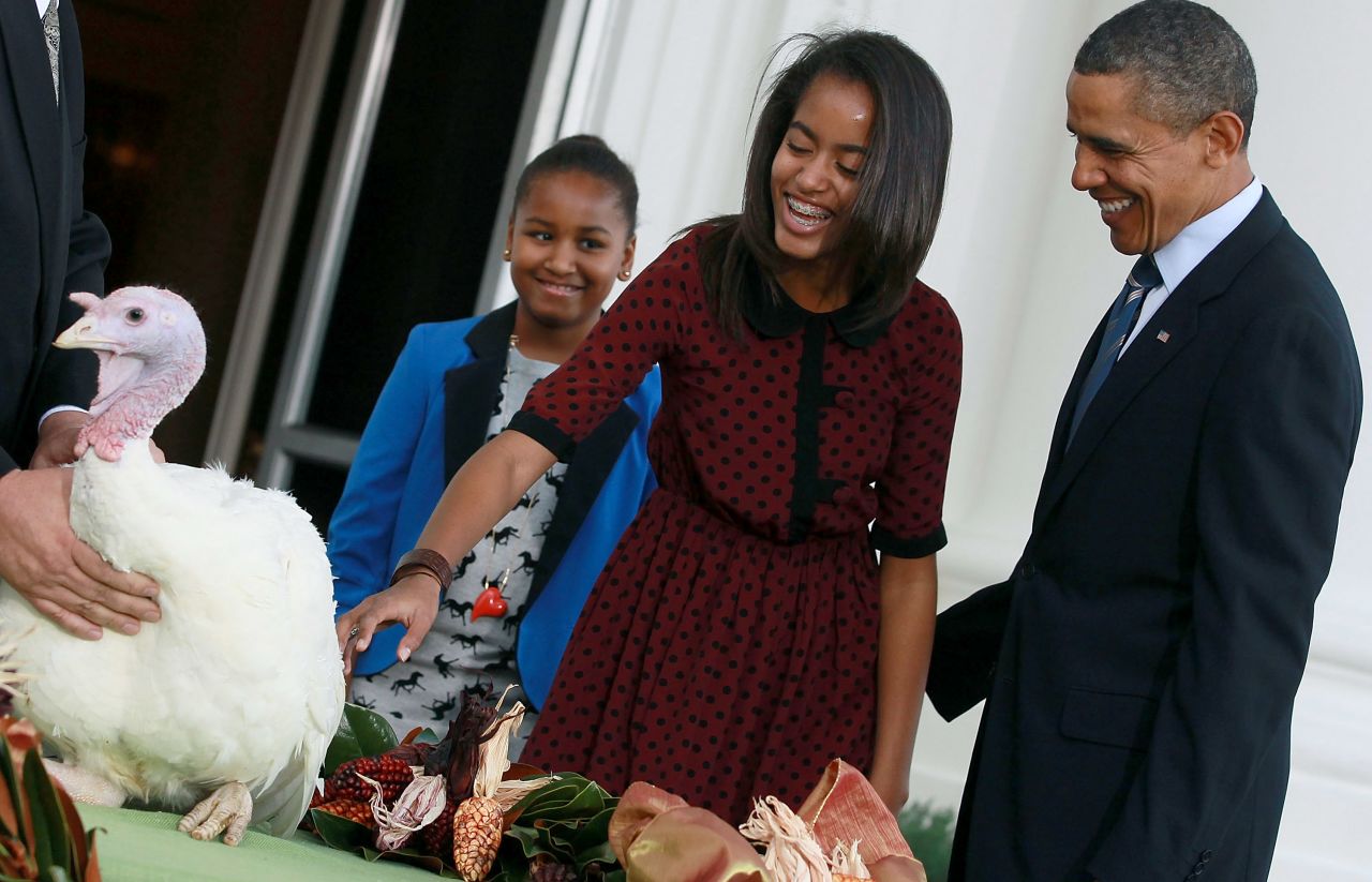 Malia Obama pets Liberty the turkey in 2011.