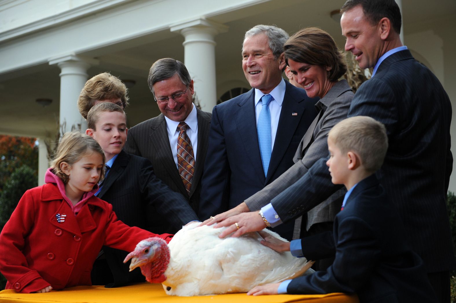 President George W. Bush stands with members of the Hill family, who raised Pumpkin the turkey, during Pumpkin's pardoning ceremony in 2008.