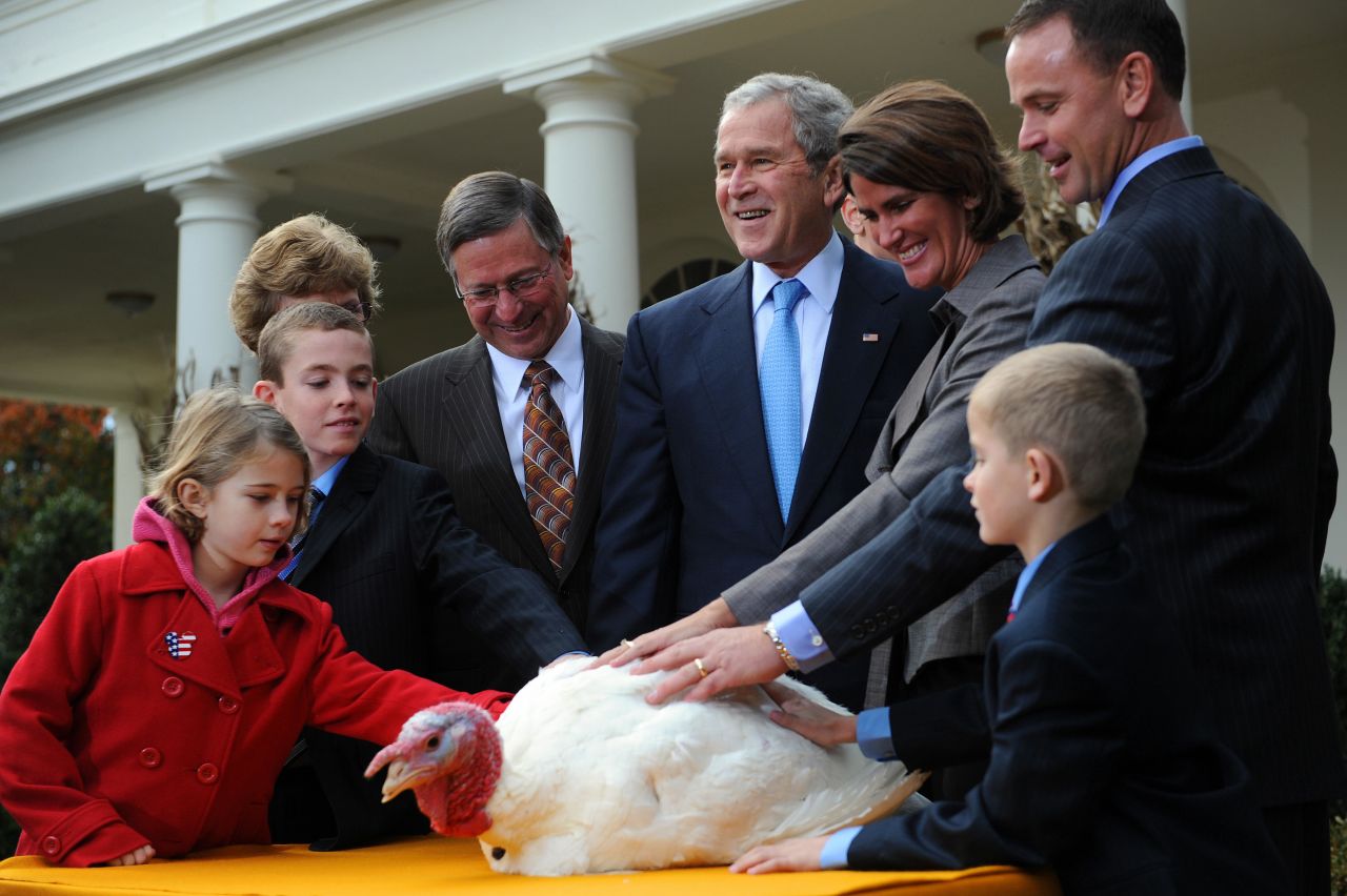 President George W. Bush stands with members of the Hill family, who raised Pumpkin the turkey, during Pumpkin's pardoning ceremony in 2008.