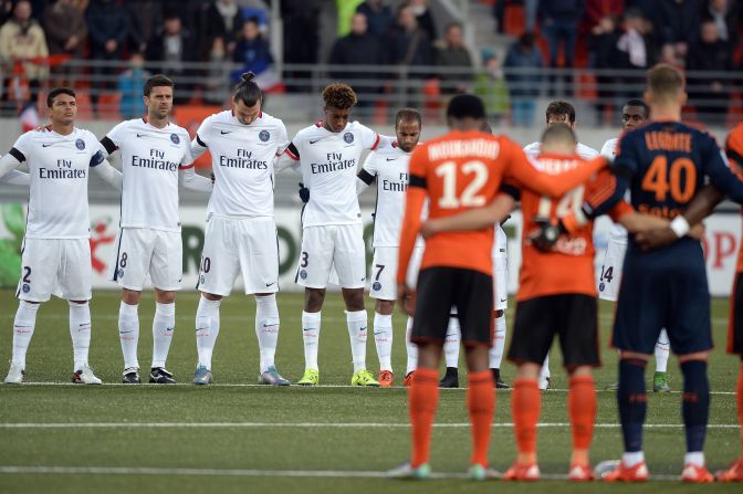 Players of PSG and Lorient observe a minute of silence in tribute to victims of Paris terror attacks.