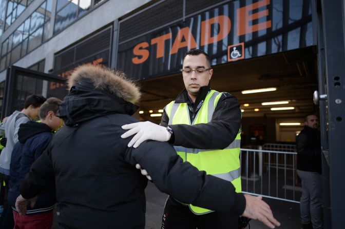 A security guard searches people outside the Moustoir stadium in Lorient.