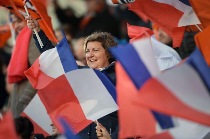 Supporters wave French flags prior to the match between Lorient and Paris Saint Germain.