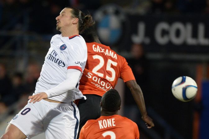 PSG's Swedish forward Zlatan Ibrahimovic (L) vies with Lorient's French Senegalese defender Lamine Gassama during the match.