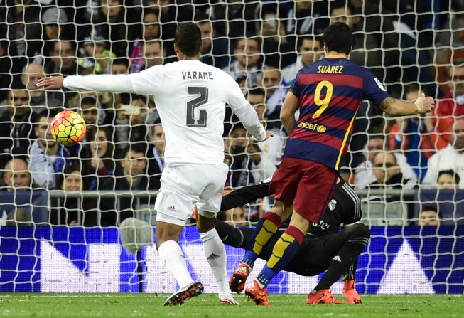 Suarez scores his second and Barca's fourth of the evening by lifting the ball over Real keeper Keylor Navas.