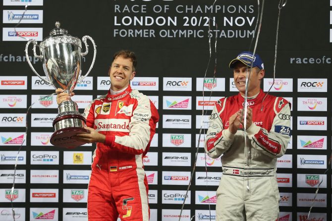 Vettel is applauded by runner- up Tom Kristensen of Denmark after winning the Race of Champions at the Olympic Stadium in London.