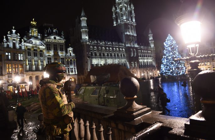 A Belgian soldier stands guard around a security perimeter as a reported police intervention takes place around the Grand Place central square in Brussels on Sunday, November 22. Multiple raids took place throughout Brussels, according to the Belgium Federal prosecutor, and 16 people were arrested. Salah Abdeslam, a suspect in Paris terror attacks, was not among them.