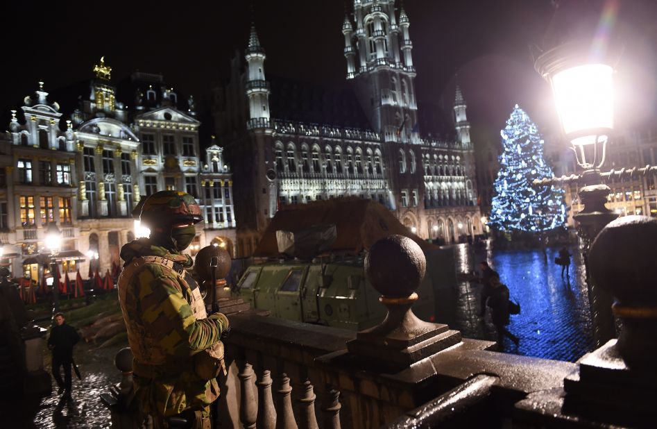 A Belgian soldier stands guard around a security perimeter as a reported police intervention takes place around the Grand Place central square in Brussels on Sunday, November 22.  Multiple raids took place throughout Brussels, according to the Belgium Federal prosecutor, and 16 people were arrested. Salah Abdeslam, a suspect in Paris terror attacks, was not among them. 