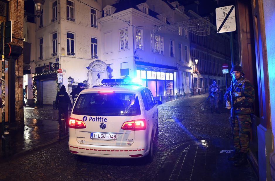 Belgian police officers and soldiers secure an area as a reported police intervention takes place around the Grand Place central square in Brussels on November 22.