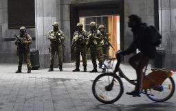 Soldiers stand guard in front of the Brussels Central Train Station on Sunday as the Belgian capital remained on the highest security alert level over fears of a Paris-style attack.     