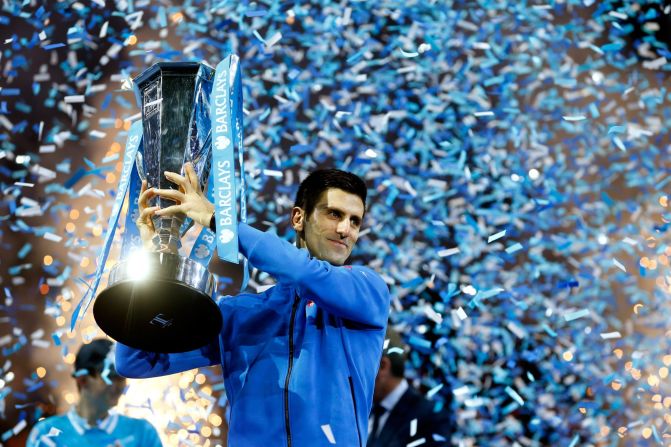 Novak Djokovic of Serbia lifts the trophy after beating Switzerland's Roger Federer of Switzerland in the final of the ATP World Tour Finals. 