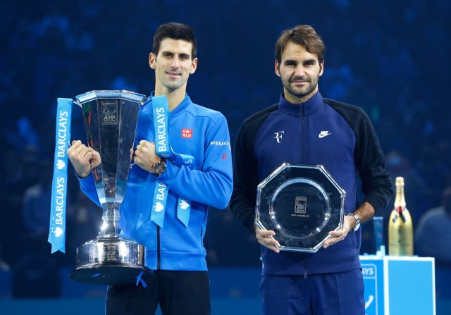 Djokovic and runner up Federer of Switzerland pose with their trophies following the final at the O2 Arena.