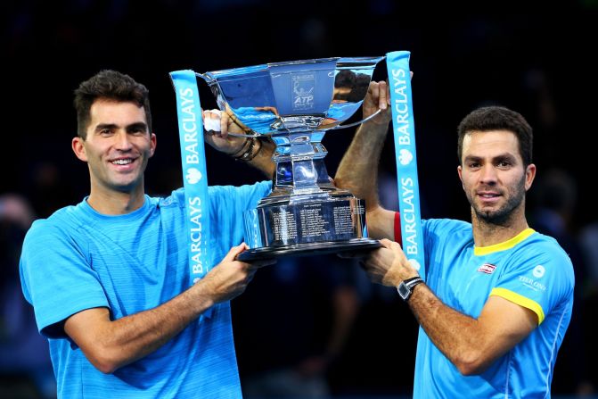 Horia Tecau of Romania and Jean-Julien Rojer of France lift the trophy after claiming the doubles title at the ATP World Tour finals, beating Rohan Bopanna of India and Florin Mergea of Romania in the final. 
