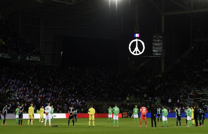 Saint-Etienne and Marseille players and fans held a minute's silence before their Ligue 1 football match Sunday. Paris' Eiffel Tower and the symbol of peace has been adopted as a <a href="index.php?page=&url=http%3A%2F%2Fedition.cnn.com%2F2015%2F11%2F15%2Fdesign%2Fpeace-for-paris%2F">unifying response</a> to the terror attacks on the city -- in which 130 people were killed. St Etienne's shirt incorporated the image for the game against Marseille.