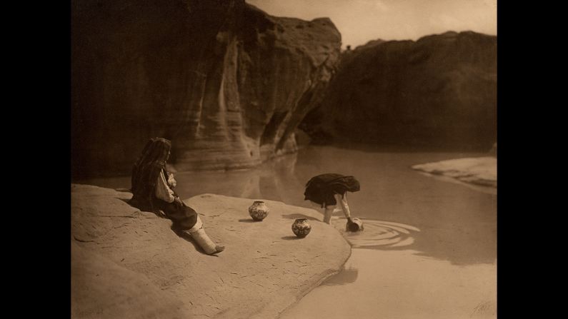 Gathering water at Acoma, circa 1904.