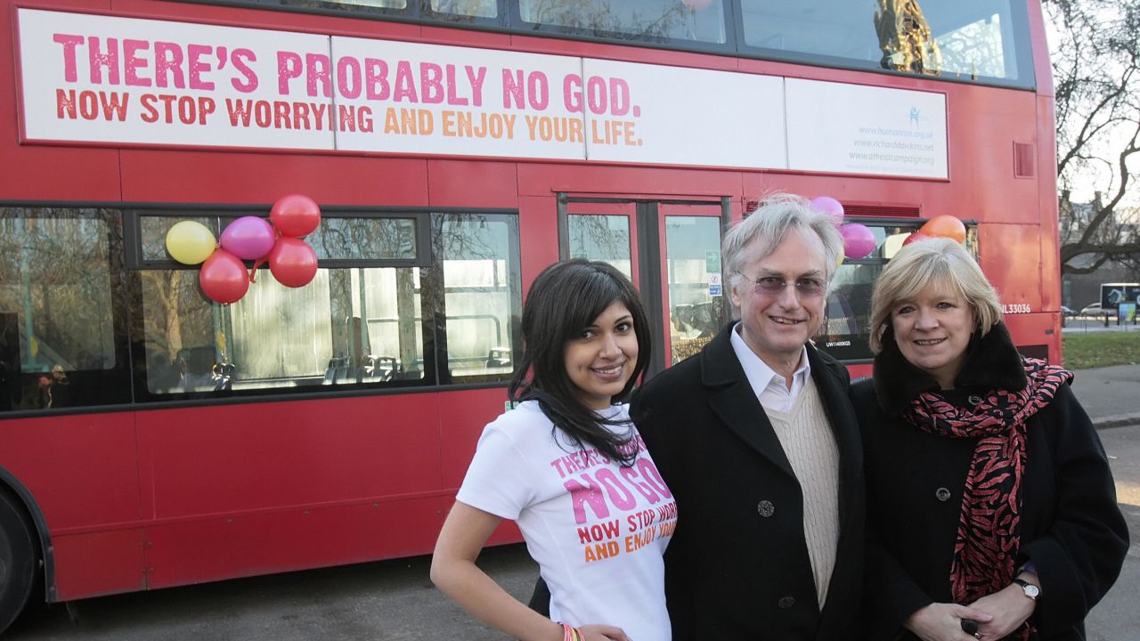 Richard Dawkins (center) and writer Polly Toynbee (right) pose in front of the controversial London bus.
