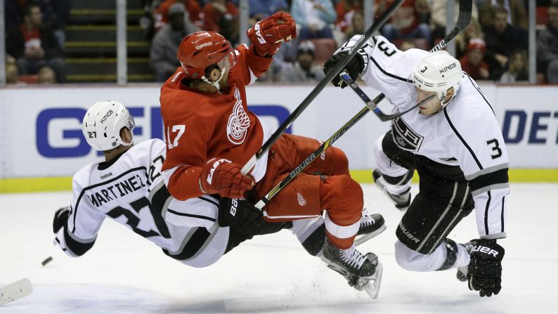 Detroit Red Wings center Brad Richards, center, collides with Los Angeles defensemen Alec Martinez and Brayden McNabb during an NHL hockey game in Detroit on Friday, November 20.