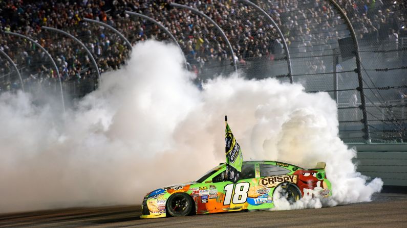 NASCAR driver Kyle Busch celebrates with a burnout after winning his first Sprint Cup championship Sunday, November 22, in Homestead, Florida. It capped off an emotional season for Busch, who missed 11 races this year after he broke his right leg and left foot in a February crash.