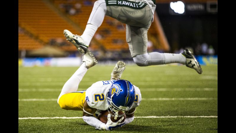 San Jose State wide receiver Tim Crawley dives into the end zone as a Hawaii player leaps over him Saturday, November 21, in Honolulu. San Jose State won the game 42-23.
