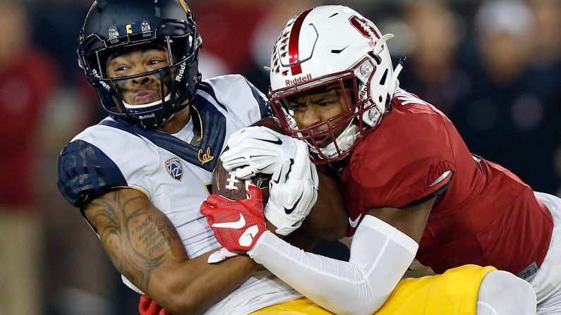 California's Bryce Treggs, left, is tackled by Stanford's Kodi Whitfield during a college football game in Palo Alto, California, on Saturday, November 21.