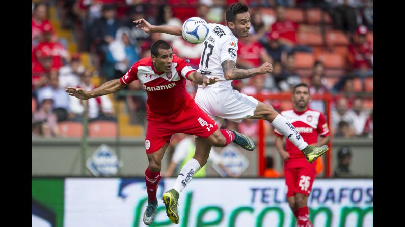 Toluca's Paulio Da Silva, left, and Monterrey's Jesus Zavala compete for the ball during a Liga MX match in Toluca, Mexico, on Sunday, November 22.