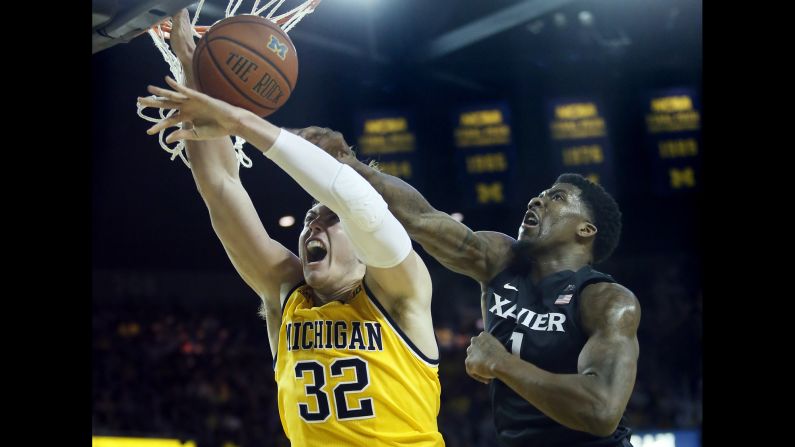 Xavier's Jalen Reynolds blocks the shot of Michigan's Ricky Doyle during a college basketball game in Ann Arbor, Michigan, on Friday, November 20.