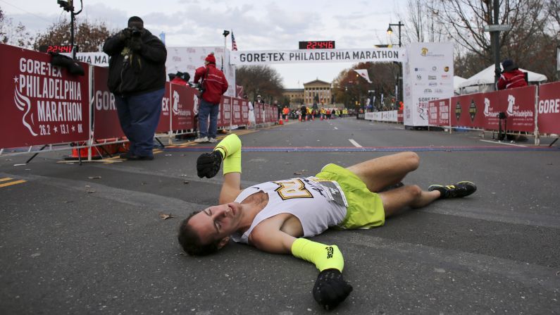 A runner collapses after crossing the finish line of the Philadelphia Marathon on Sunday, November 22.