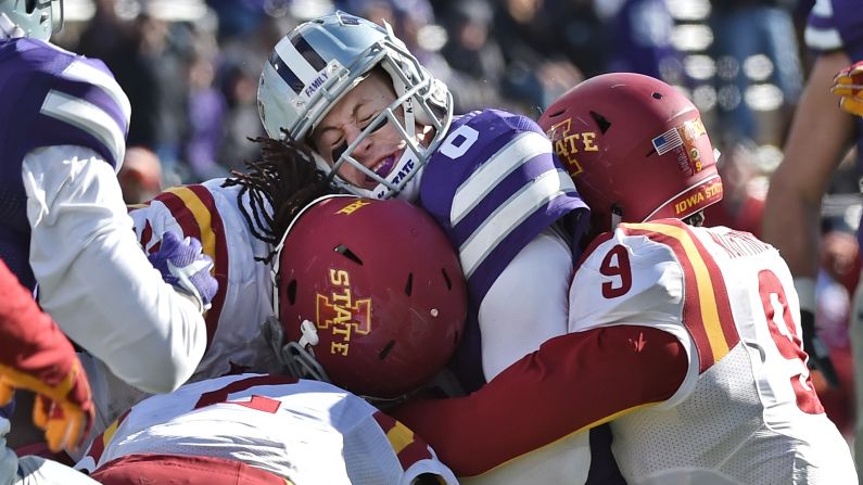 Kansas State quarterback Joe Hubener is crunched by Iowa State defenders during their game in Manhattan, Kansas, on Saturday, November 21.