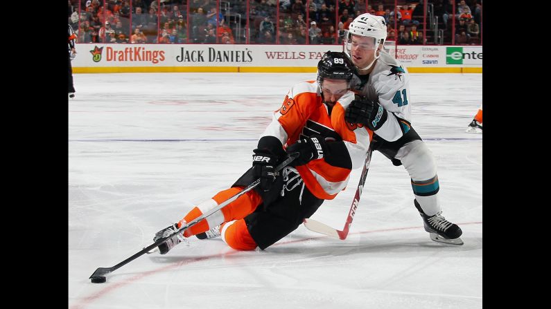 Philadelphia's Sam Gagner maintains possession of the puck as he's shoved by San Jose's Mirco Mueller on Thursday, November 19.