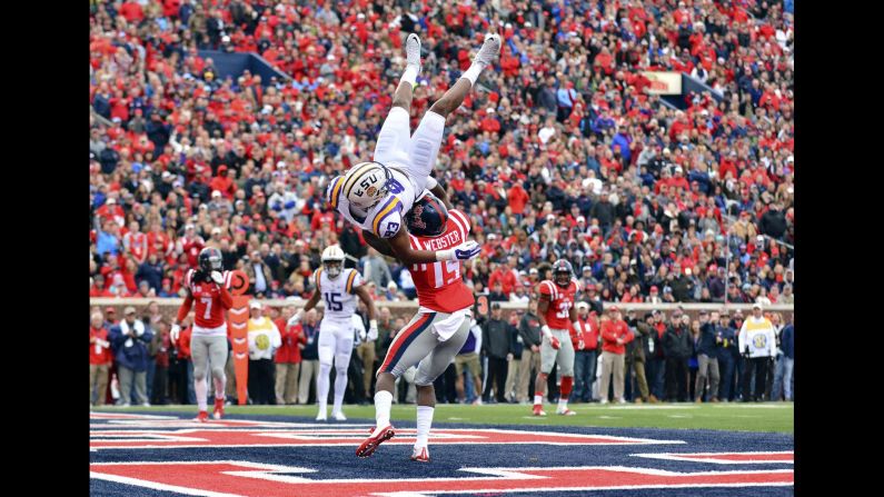 LSU wide receiver Travin Dural flips over Mississippi's Kendarius Webster on an incomplete pass Saturday, November 21, in Oxford, Mississippi. Dural was injured on the play and didn't return to the game.
