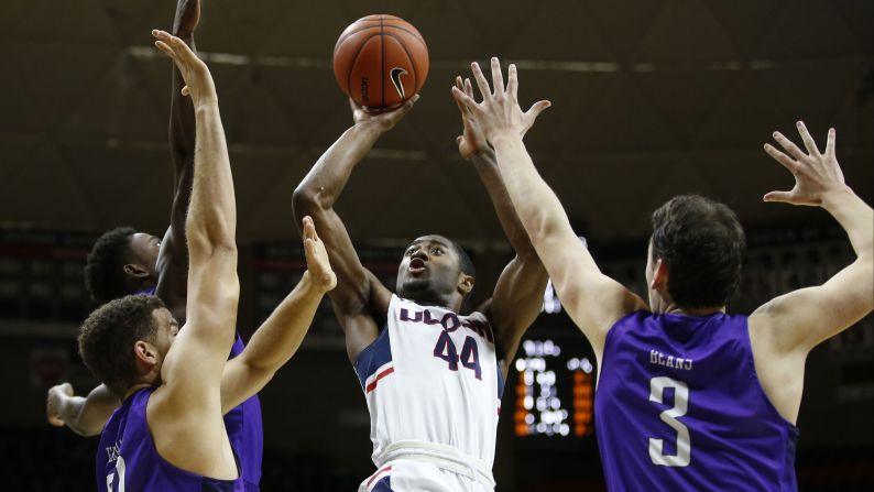 Connecticut guard Rodney Purvis shoots over three Furman defenders during a college basketball game in Storrs, Connecticut, on Saturday, November 21.