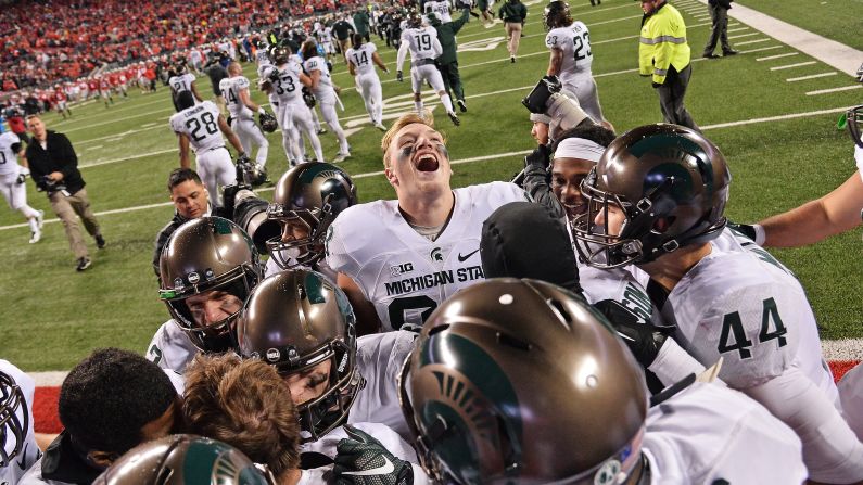 Michigan State football players celebrate Saturday, November 21, after they upset undefeated Ohio State 17-14 in Columbus, Ohio. Michael Geiger kicked a 41-yard field goal as time expired to put the Spartans on the cusp of a division title.