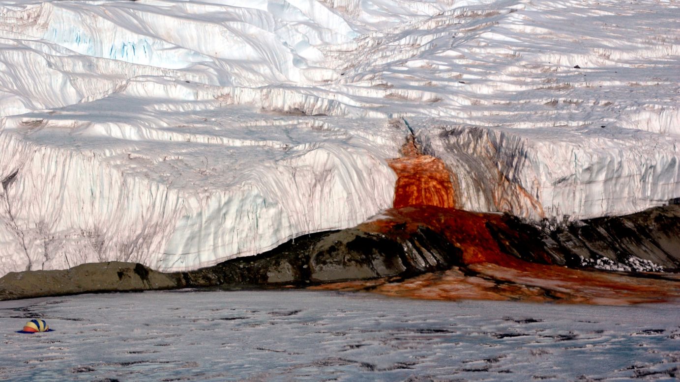 Antarctica's eerie Blood Falls flows from the end of the Taylor Glacier into ice-covered Lake Bonney. The water comes from a buried saltwater reservoir rich in iron. The liquid oxidizes at the surface, giving it that gruesome hue. At left, a tent provides a sense of scale.