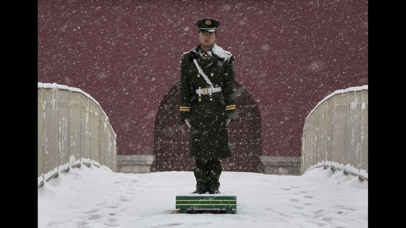 A Chinese paramilitary police officer stands guard outside Tiananmen Gate in Beijing.