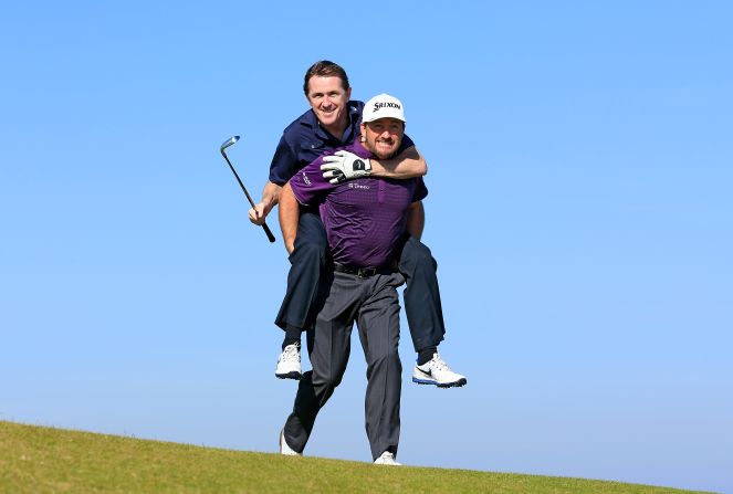 Much of his retirement has been spent on the golf course. Here he is getting in the saddle with Graeme McDowell.