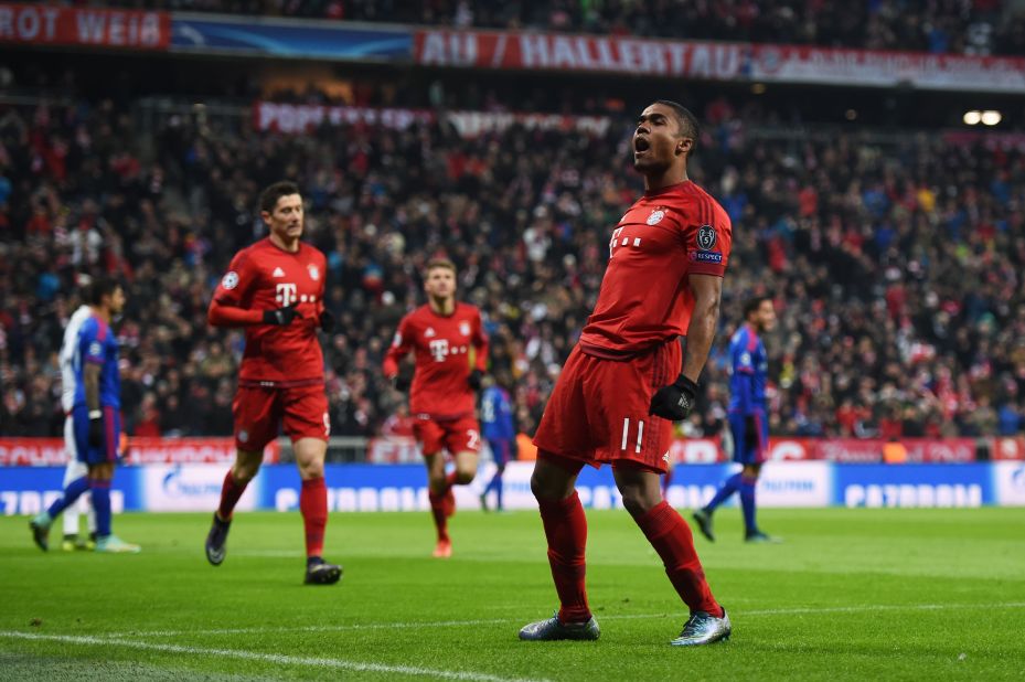 Douglas Costa of Bayern Munich scores his team' s opening goal against Olympiakos in the Allianz Arena.