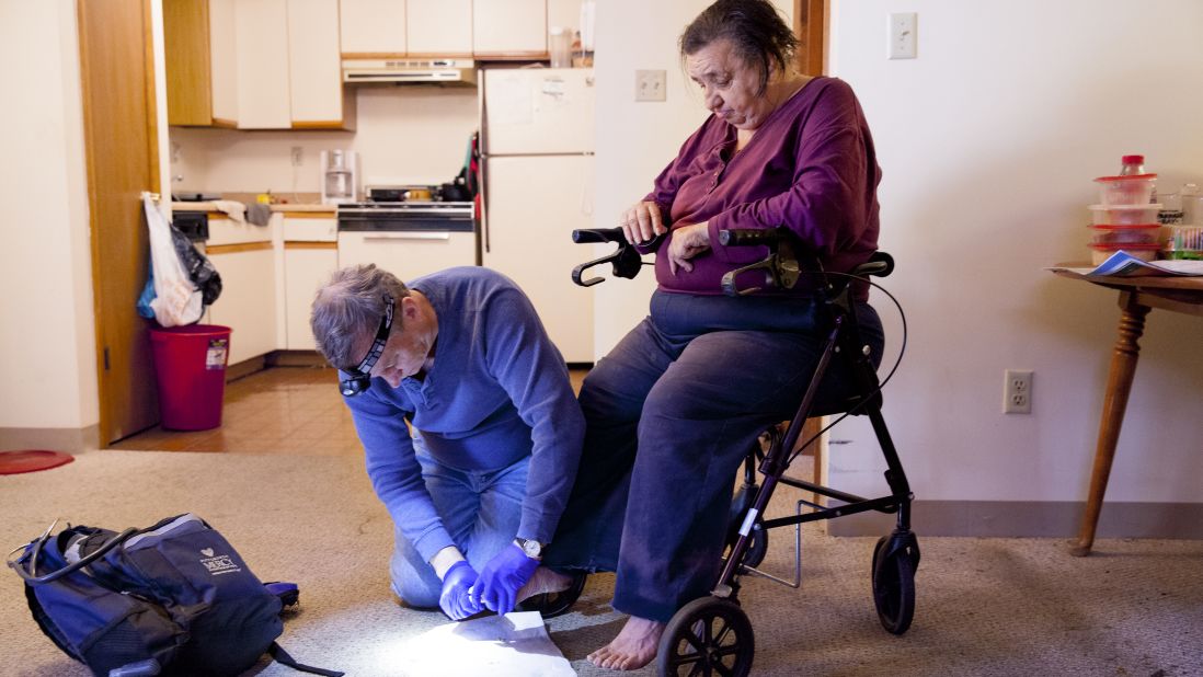 Withers and his group have reached more than 10,000 individuals and helped more than 1,200 of them transition into housing. Withers met Lois -- pictured here, receiving a home visit -- when she was living on the streets.