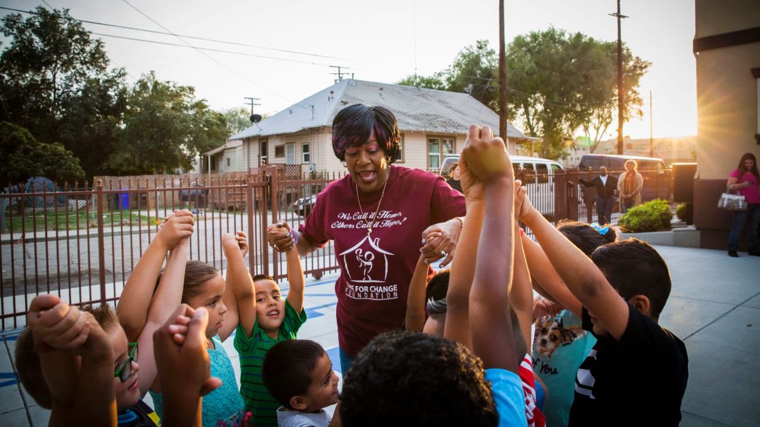 Carter plays a game with children and their mothers at the foundation's affordable housing complex in San Bernardino, California.