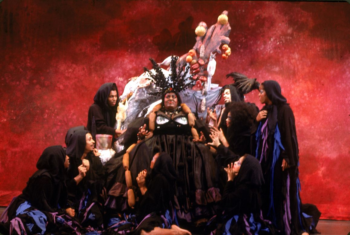 King, surrounded by cast members, acts out a scene.