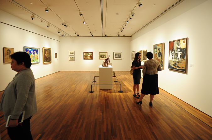 Visitors view artworks at the National Gallery Singapore, which opened on November 24, 2015.