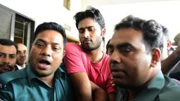 Bangladeshi security personnel escort fugitive cricketer Shahadat Hossain (C) after he surrendered in Dhaka on October 5, 2015. Hossain was remanded in jail on October 5 shortly after he surrendered to a court over allegations of beating his 11-year-old maid, his lawyer said. AFP PHOTO / MUNIR UZ ZAMAN        (Photo credit should read MUNIR UZ ZAMAN/AFP/Getty Images)