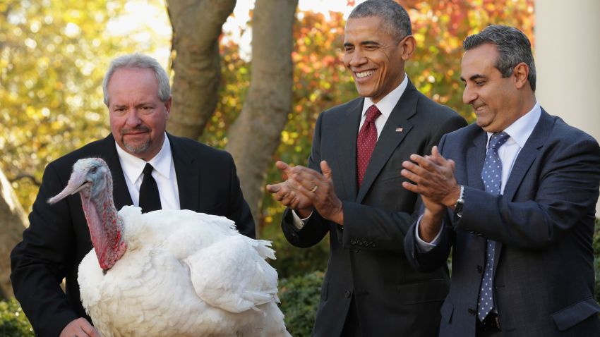 U.S. President Barack Obama "pardons" Abe, a 42-pound male turkey during a ceremony with Jihad Douglas (R), chairman of the National Turkey Federation, in the Rose Garden at the White House  November 25, 2015 in Washington, DC. 