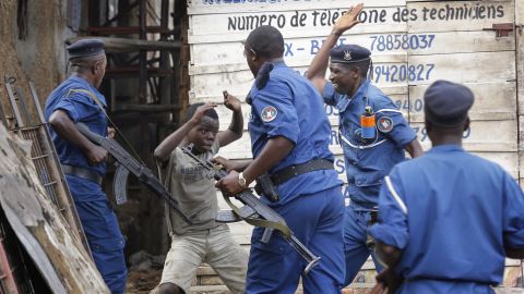 <strong>May 26:</strong> A young boy tries to cover himself as police officers beat him at an anti-government demonstration in Bujumbura, Burundi. Police fired shots to disperse people protesting against President Pierre Nkurunziza and his bid for a third term.