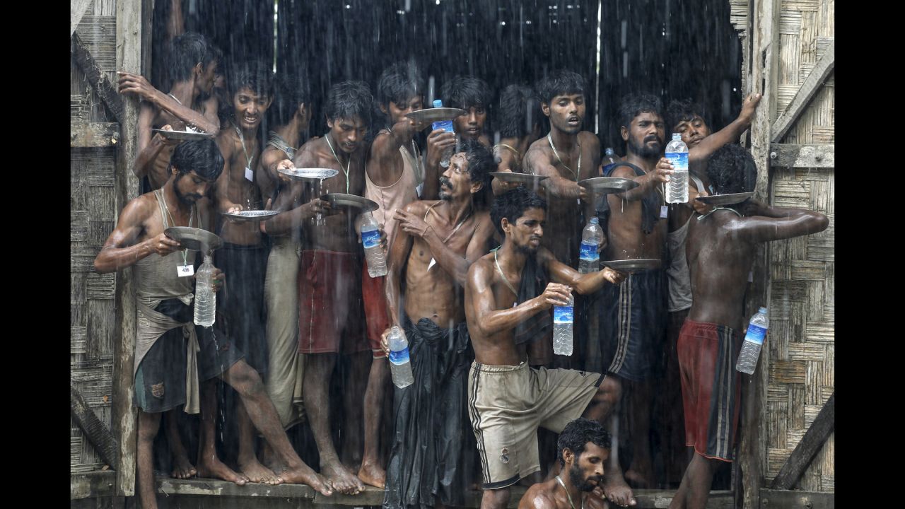 <strong>June 4:</strong> Migrants who were found at sea collect rainwater at a temporary shelter in Myanmar. Myanmar, which had previously disavowed responsibility for Rohingya migrants stranded at sea, <a href="http://www.cnn.com/2015/05/22/asia/asian-boat-migrants-rescue/index.html" target="_blank">said it would provide search and rescue for "boat people" in its territorial waters.</a> Thousands of Rohingya -- minority Muslims in Myanmar -- and economic migrants from Bangladesh had taken to sea in recent weeks, hoping to settle elsewhere in Southeast Asia.