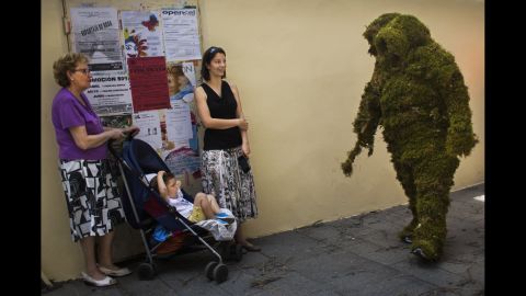 <strong>June 7:</strong> A "moss man" marches during the Corpus Christi procession in Bejar, Spain. The annual procession commemorates Christians who used moss as camouflage to hide from Muslim guards and re-conquer the town in the 12th century.
