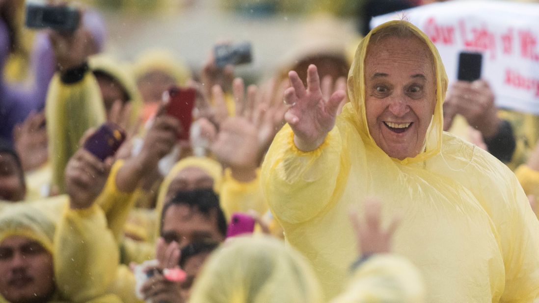 <strong>January 17: </strong>Pope Francis wears a plastic poncho as he waves to well-wishers after a Mass in Tacloban, Philippines. During his five-day trip to the country, the Pope visited areas devastated by Typhoon Haiyan in 2013.