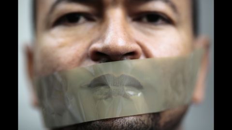 <strong>June 22:</strong> A man with tape over his mouth attends a demonstration in Berlin. The demonstration was held to support Ahmed Mansour, a senior journalist with Al Jazeera who was detained in Germany at the request of the Egyptian government. He was later released.