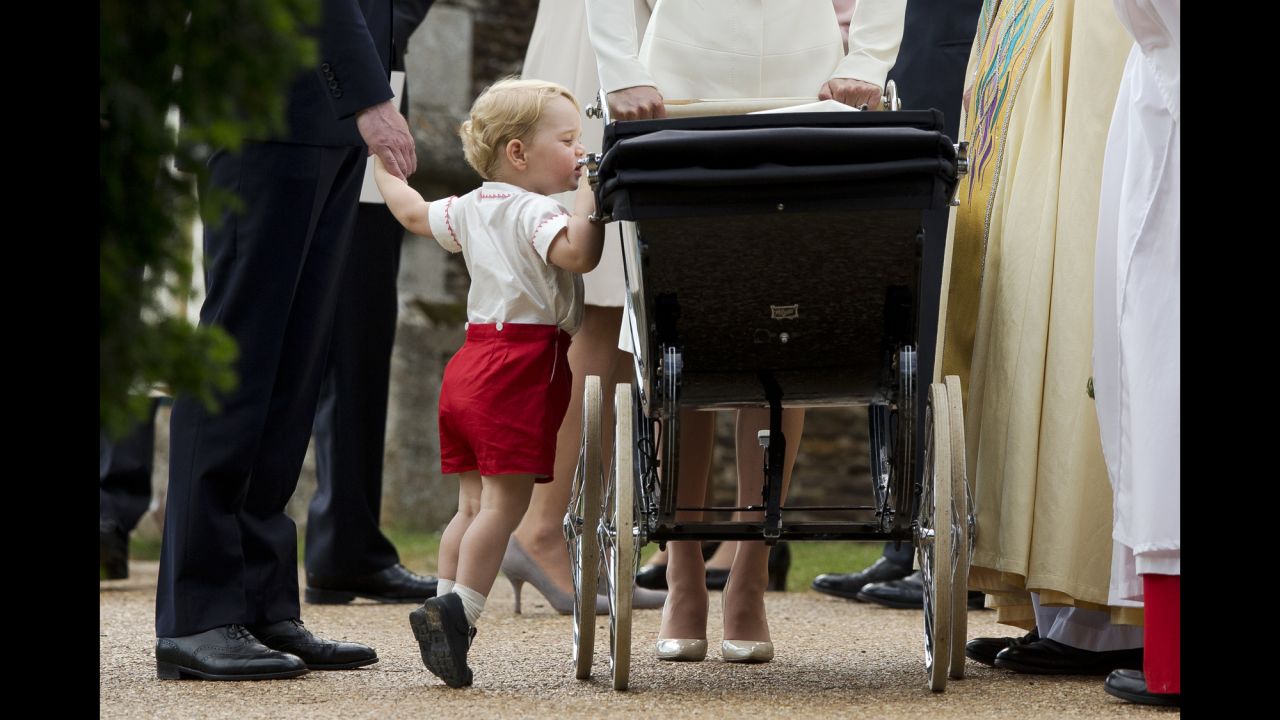 <strong>July 5:</strong> Britain's Prince George peeks into the carriage holding his sister, Princess Charlotte, <a href="http://www.cnn.com/2015/05/02/world/gallery/royal-baby-princess-announced/index.html" target="_blank">after her christening</a> in Norfolk, England.