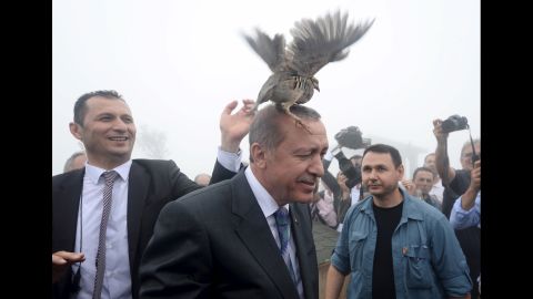 <strong>August 14:</strong> Turkish President Recep Tayyip Erdogan, center, releases a bird during an opening ceremony for a new mosque in Rize, Turkey.