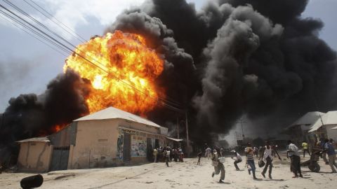 <strong>February 23:</strong> People run from an explosion at a gas station and storage facility near the Bakara market in Mogadishu, Somalia.