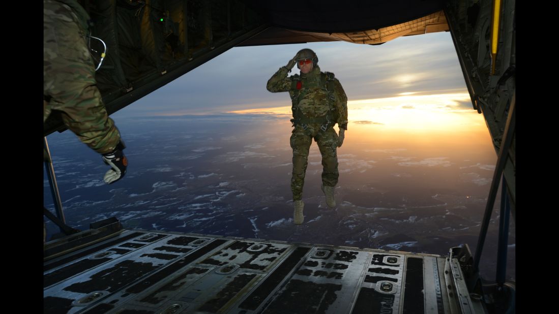 <strong>February 24:</strong> A U.S. soldier salutes while jumping out of an aircraft in Germany.